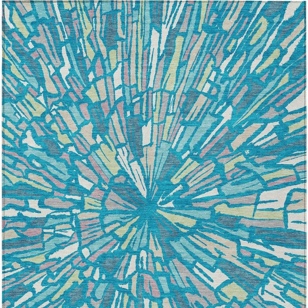 Teal blue abstract area rug with radial burst sunburst pattern, cream and green details