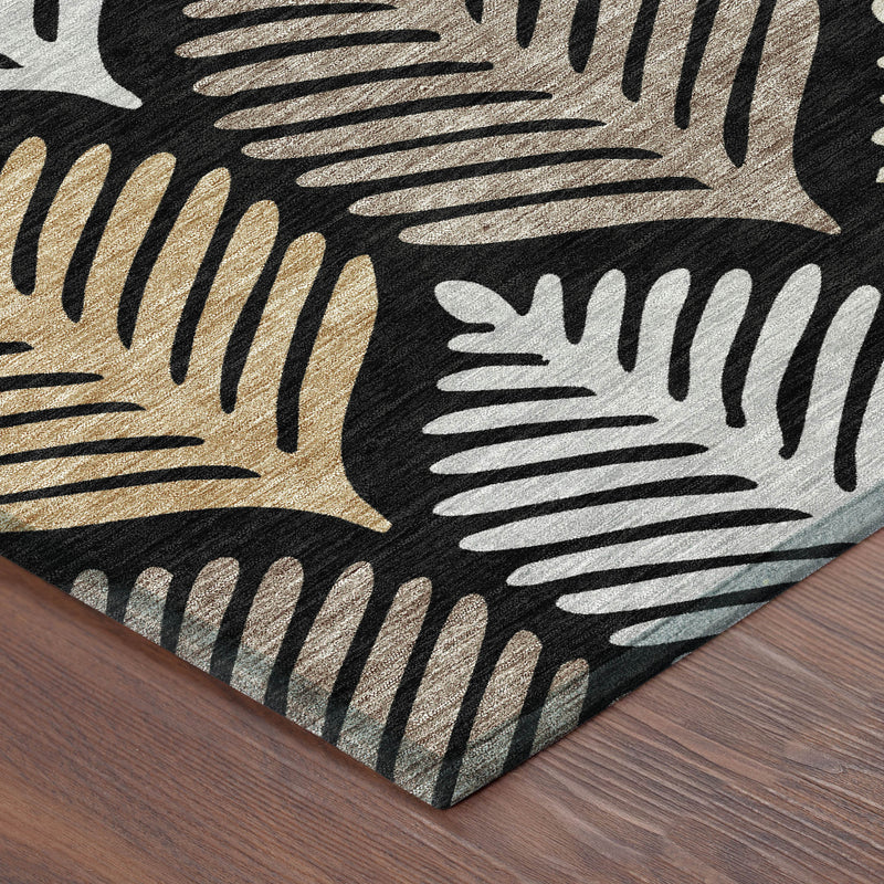 Black and gray leaf-pattern area rug corner with beige and gold accents.