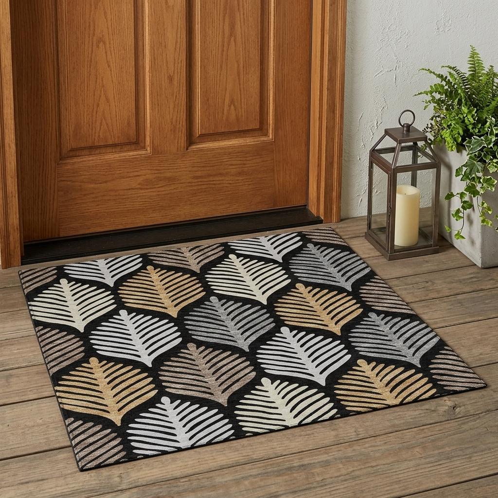 Rectangular black and gray leaf-pattern indoor outdoor area rug with beige and gold.