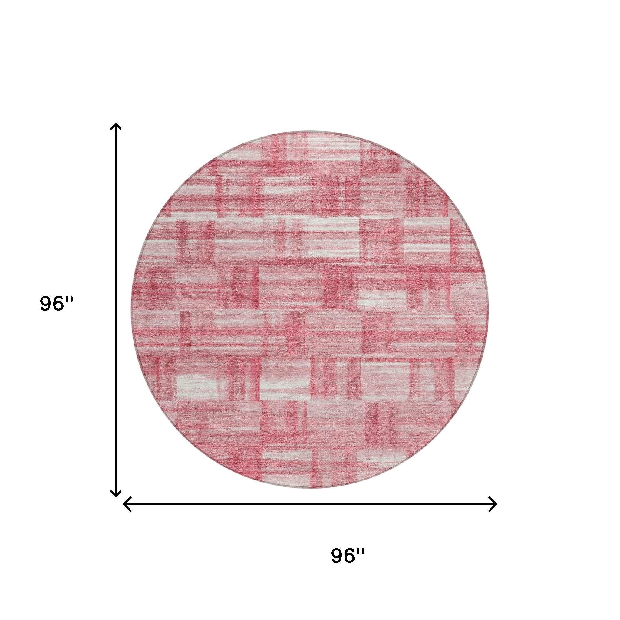 Round pink and ivory area rug with distressed grid patchwork pattern