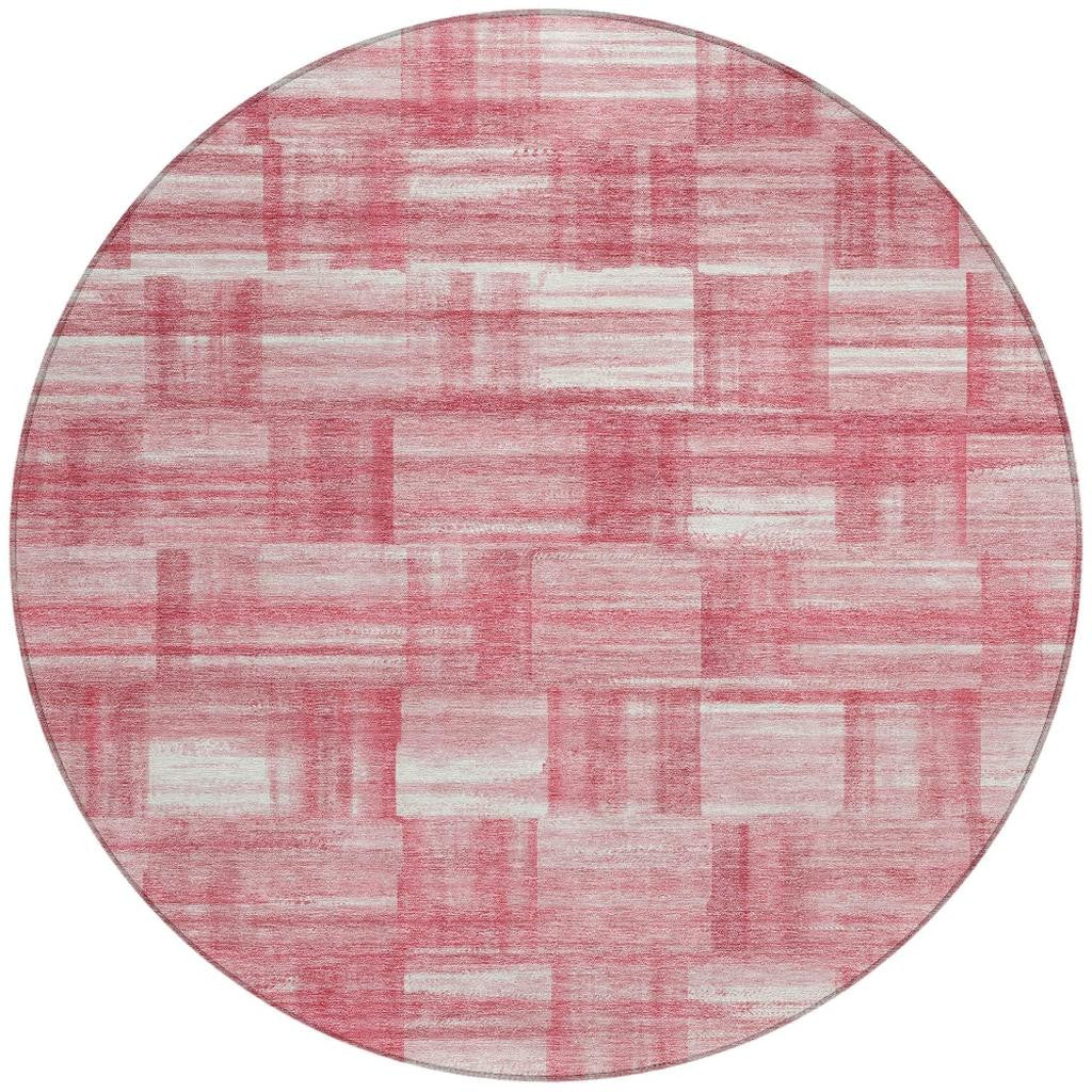 Round pink and ivory rug with distressed horizontal and vertical stripe blocks
