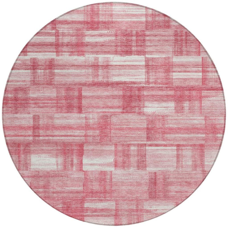 Round pink and ivory rug with distressed horizontal and vertical stripe blocks