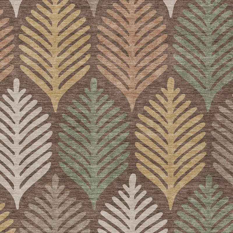 Close-up of brown indoor outdoor rug with beige, tan, green, and white leaf design