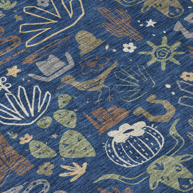 Close-up of navy area rug with cactus and sunburst icons in tan and gray