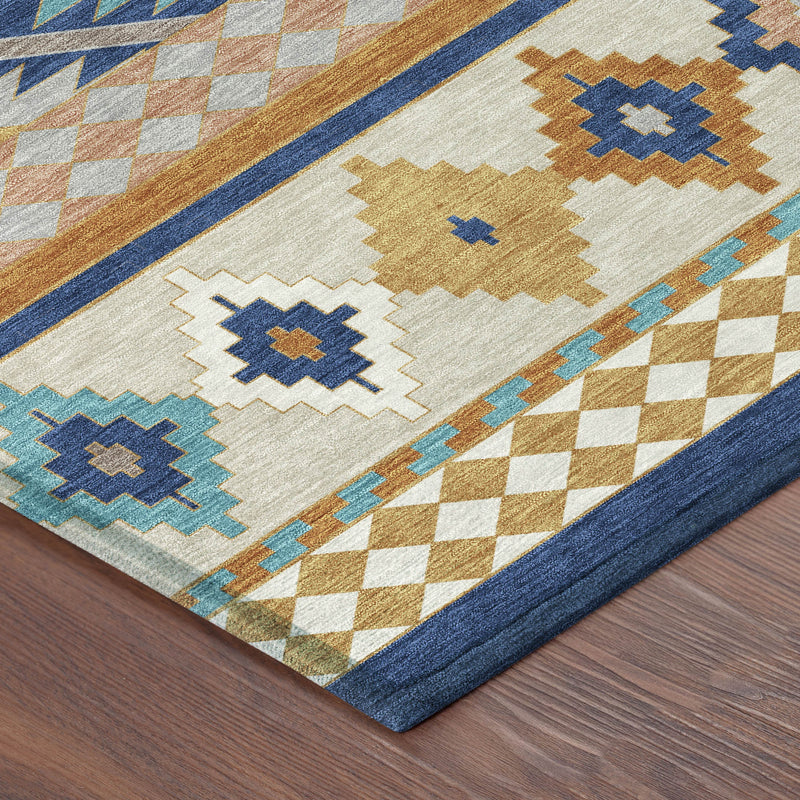 Geometric corner of area rug with navy border, ivory field, and teal/tan cross diamonds.