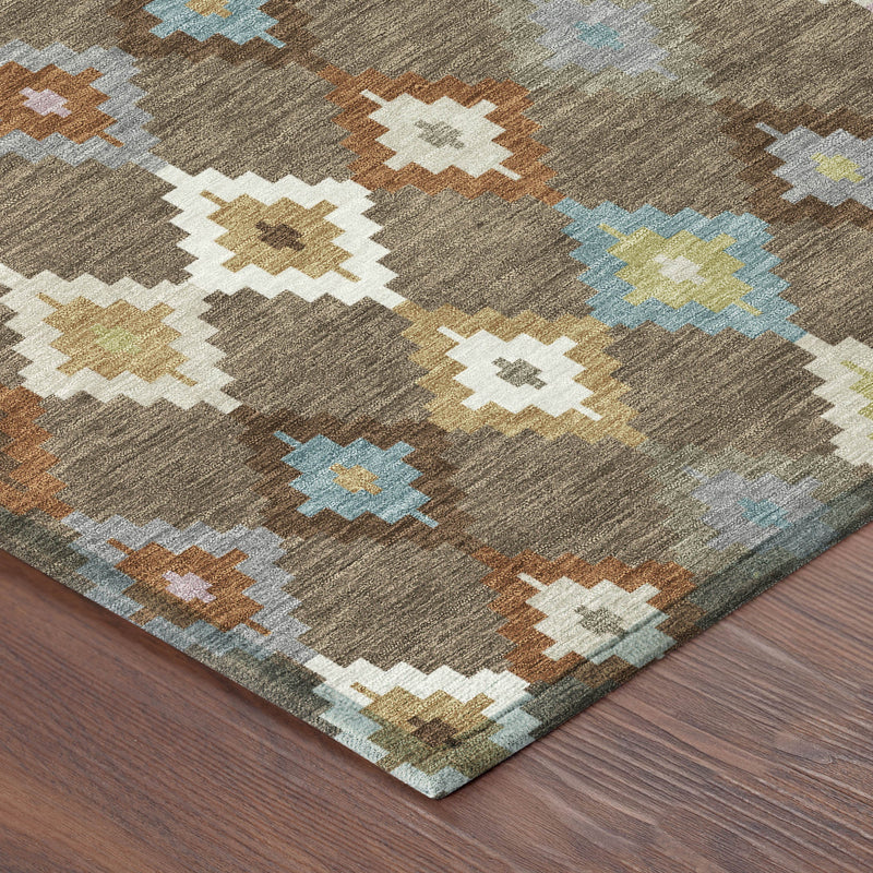 Corner view of round rug with brown field and multicolor geometric Aztec design