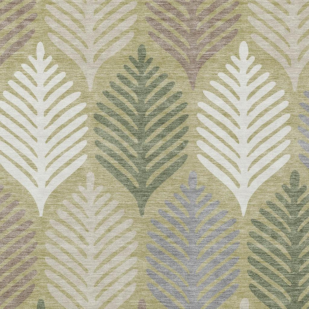 Area rug with repeating leaf silhouettes in ivory, sage green, and muted blue-gray tones