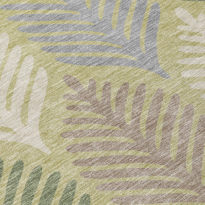 Close-up area rug showing textured leaf pattern in green, ivory, and taupe-gray
