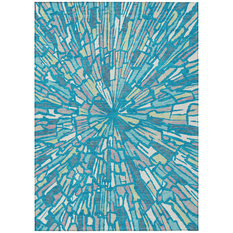 Abstract area rug with teal and blue radial burst pattern on a light base