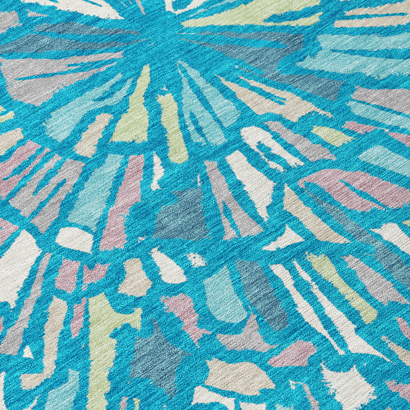 Textured abstract rug surface in teal blue with white rays and subtle green tones