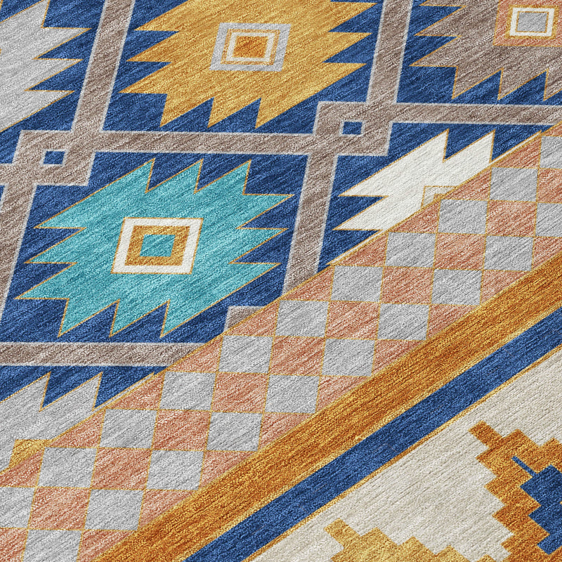 Close-up southwestern area rug with blue starburst motif and tan orange checker blocks
