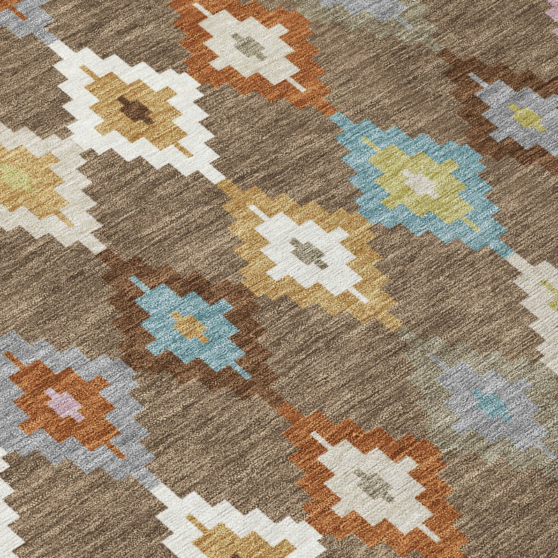 Aztec diamond patterned area rug on a gray-brown base with teal and orange accents.