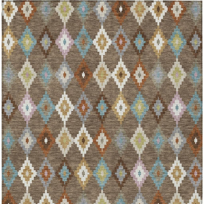 Close-up Aztec diamond area rug in gray-brown with teal, orange, pink, and ivory colors.