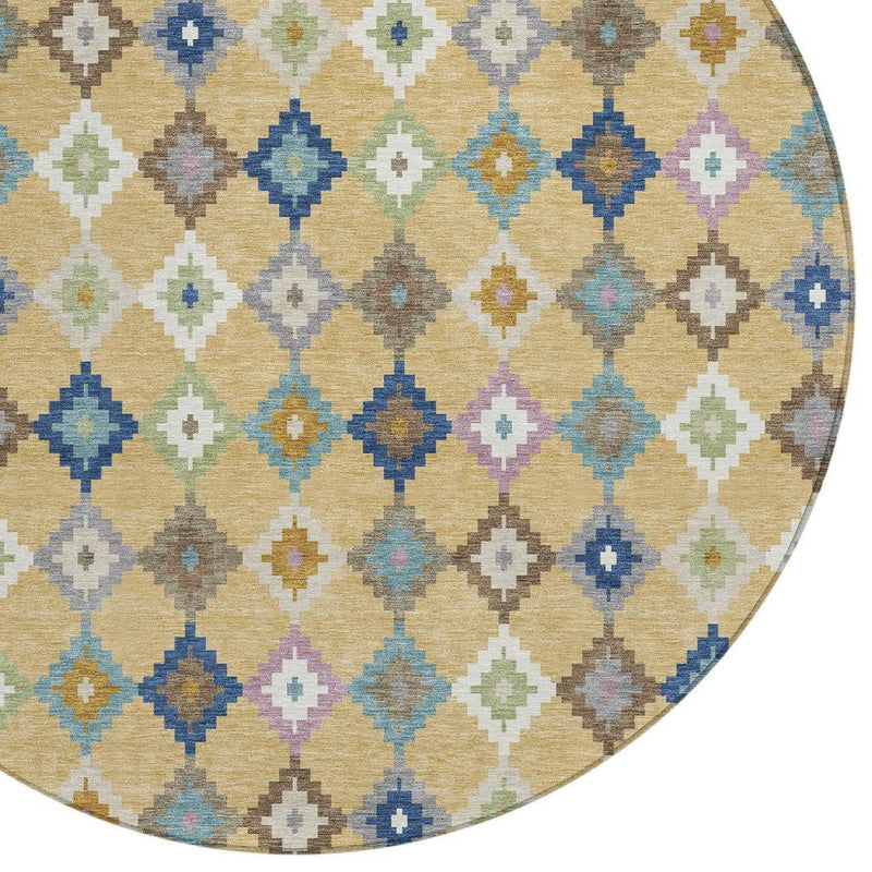 Close-up of round rug showing beige-gold ground with blue, teal, green, and pink diamonds.