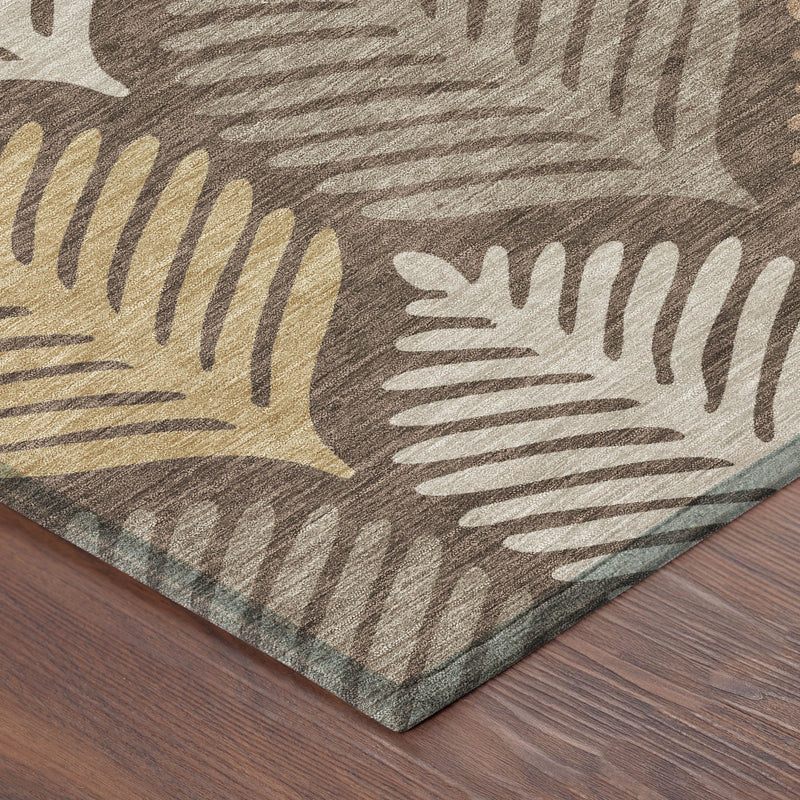 Corner of chocolate brown and beige leaf pattern area rug on wood flooring