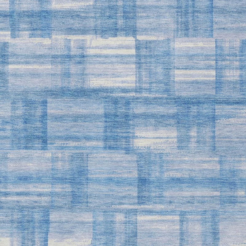 Blue and ivory patchwork rug texture with distressed stripes
