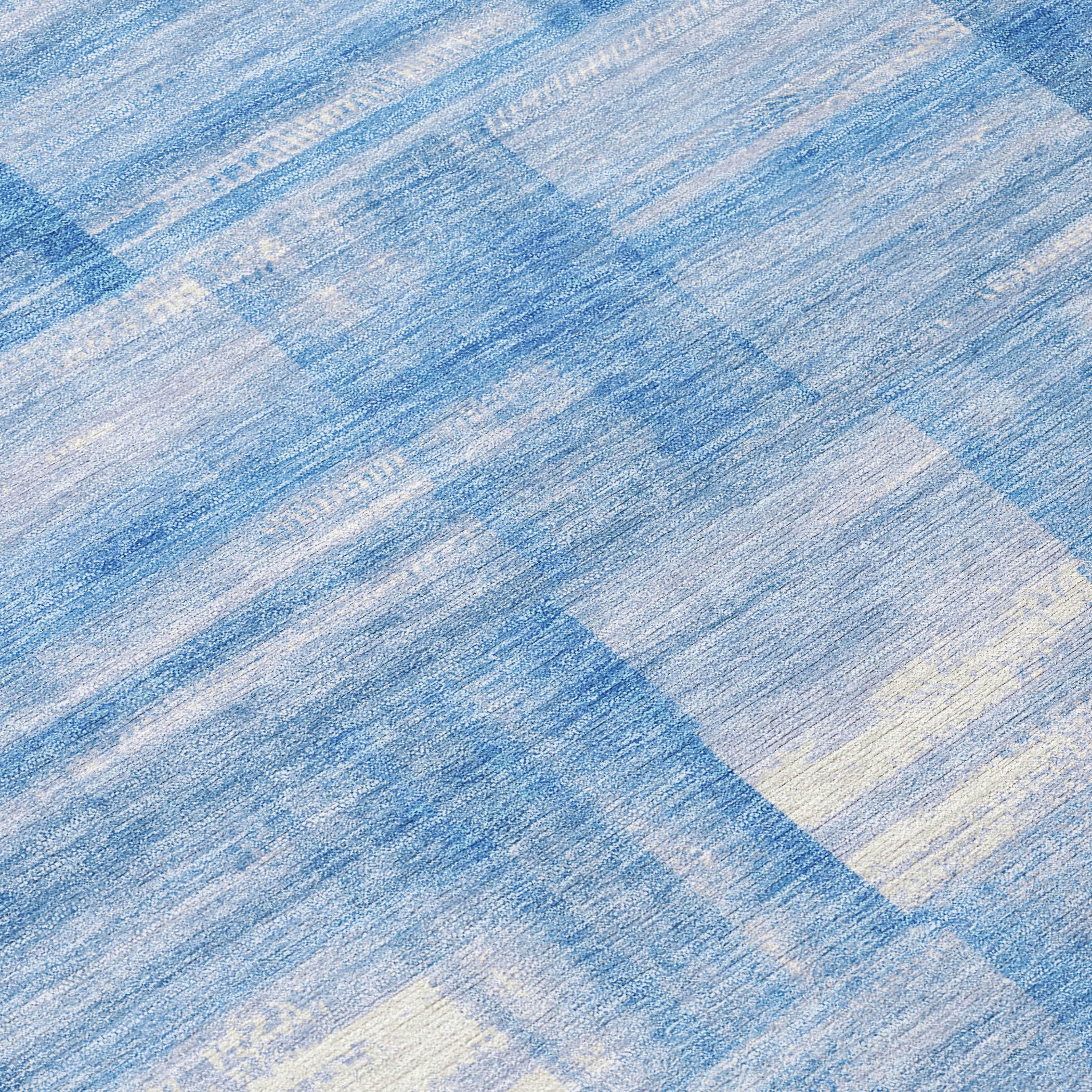 Denim blue and ivory striped rug with distressed woven texture