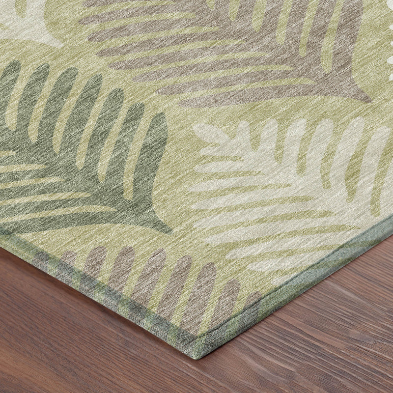 Corner view of area rug with muted green and ivory leaf pattern and bordered edge