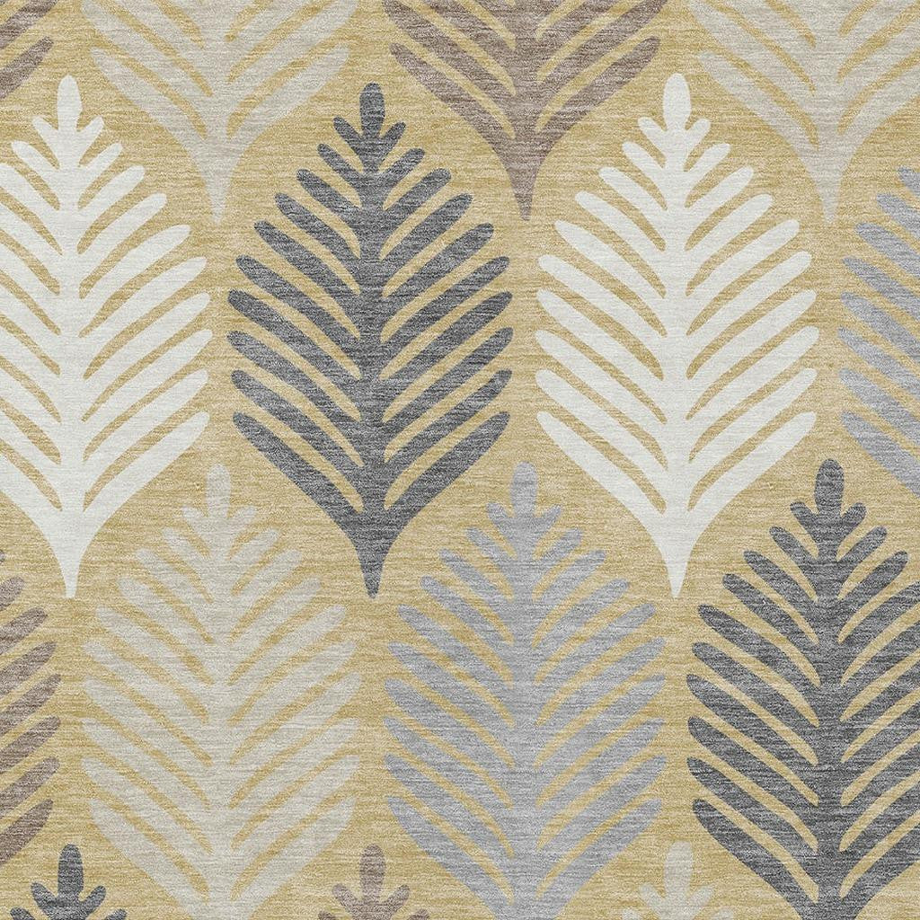 Indoor outdoor area rug close-up of ivory and gold leaf silhouettes with gray