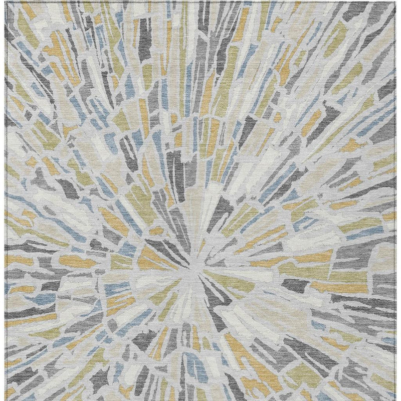 Abstract area rug showing centered silver-gray sunburst with blue and gold accents