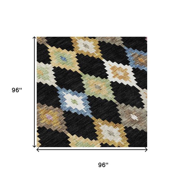 Round area rug with black, beige, and multicolor Aztec zigzag diamond pattern