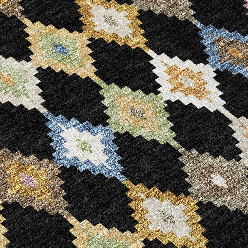 Close-up round rug design with black base and beige, blue, green Aztec diamonds