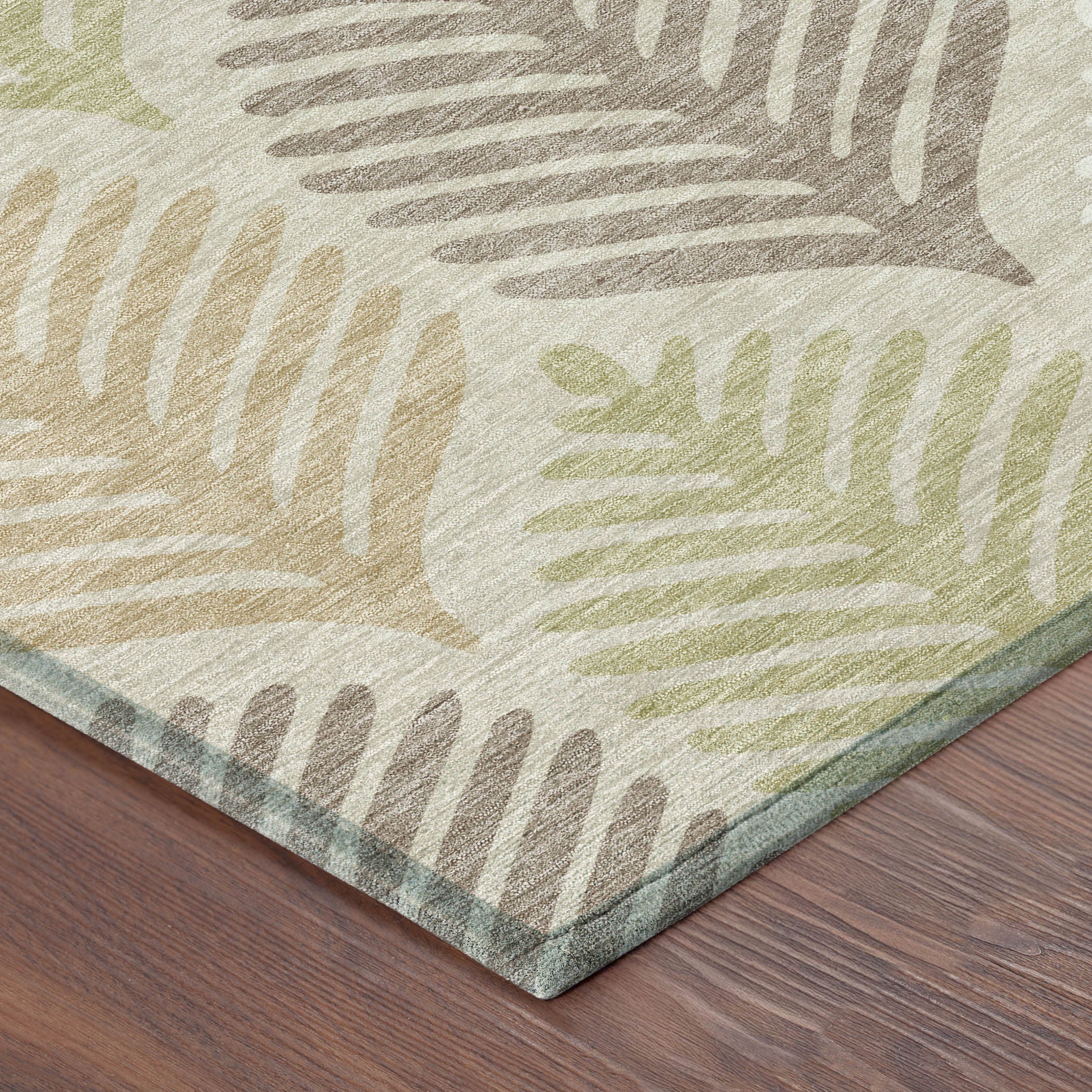 Corner view of beige and ivory round rug with multicolor leaf pattern