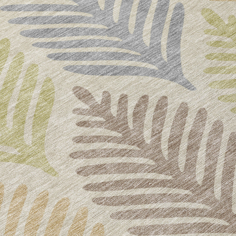 Close-up of beige and ivory round rug with layered leaf silhouettes in muted colors