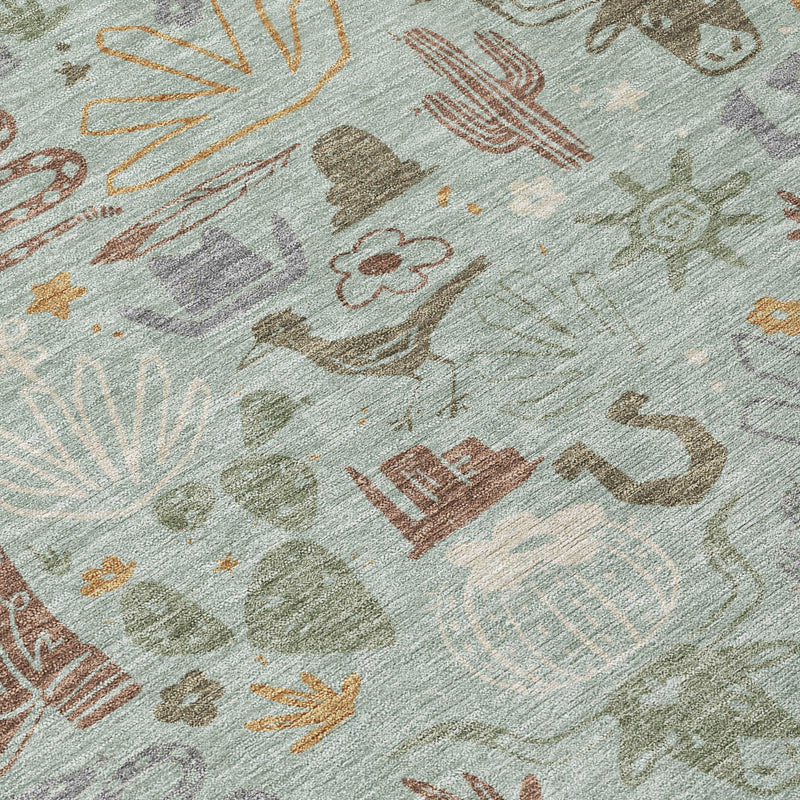 Close-up of sage green rug with cactus, sun, and animal icons in warm gold and brown