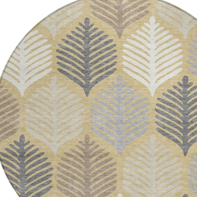 Round area rug close-up: ivory and gold ground with blue-gray leaf silhouettes