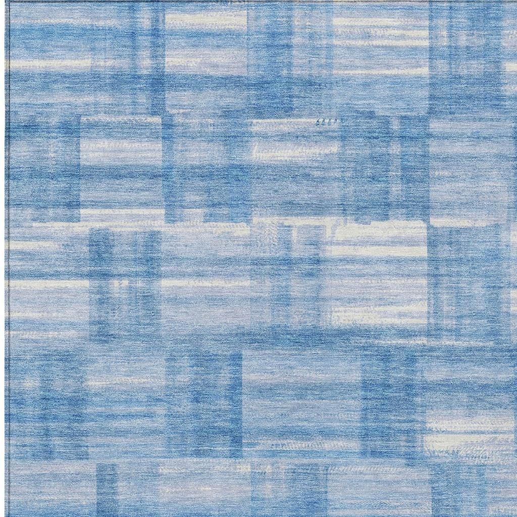 Blue and ivory patchwork grid area rug surface detail, mottled texture