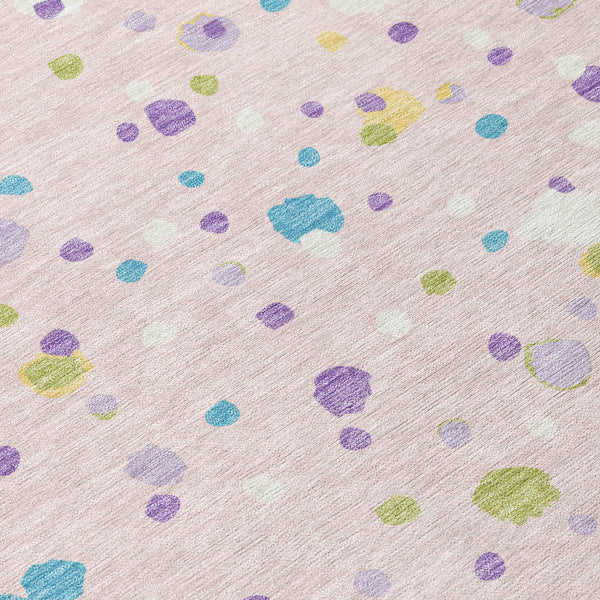 Pink and ivory area rug with scattered multicolor pebble shapes pattern