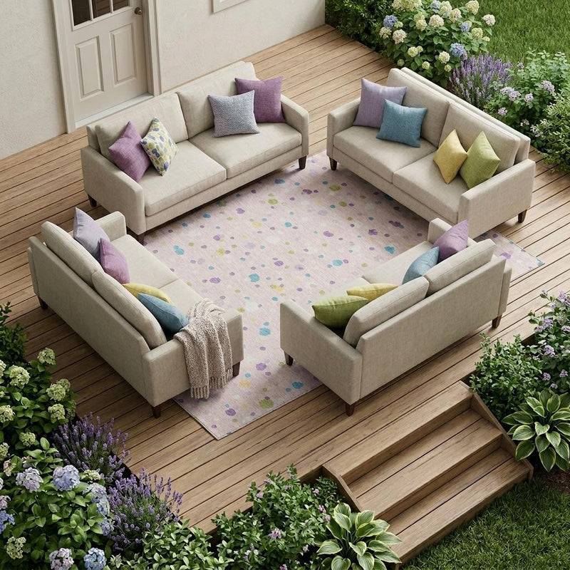 Pink and ivory indoor/outdoor area rug with scattered multicolor pebble pattern under patio seating