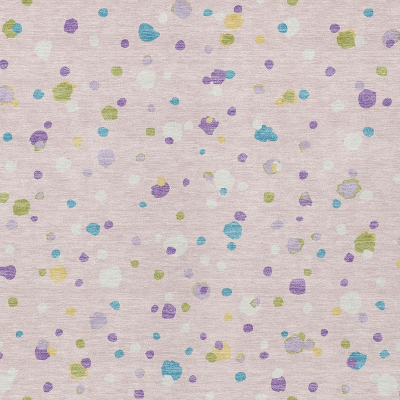 Pink and ivory area rug close-up with small colorful geometric dot pattern