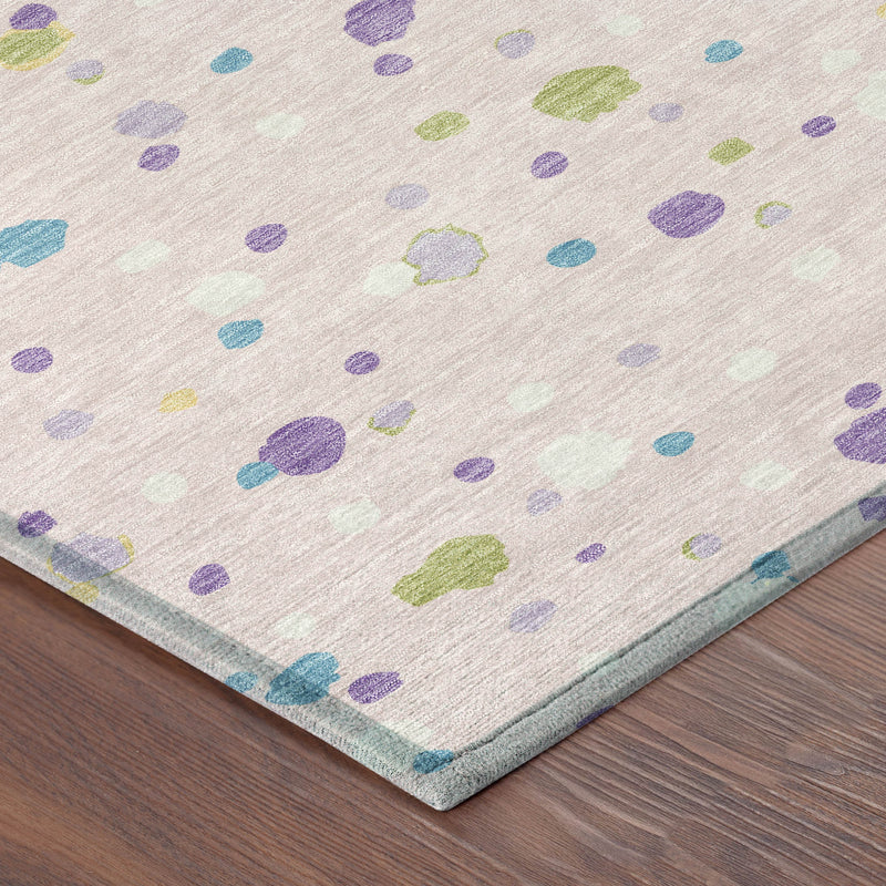 Pink and ivory area rug corner with colorful geometric pattern and low pile edge