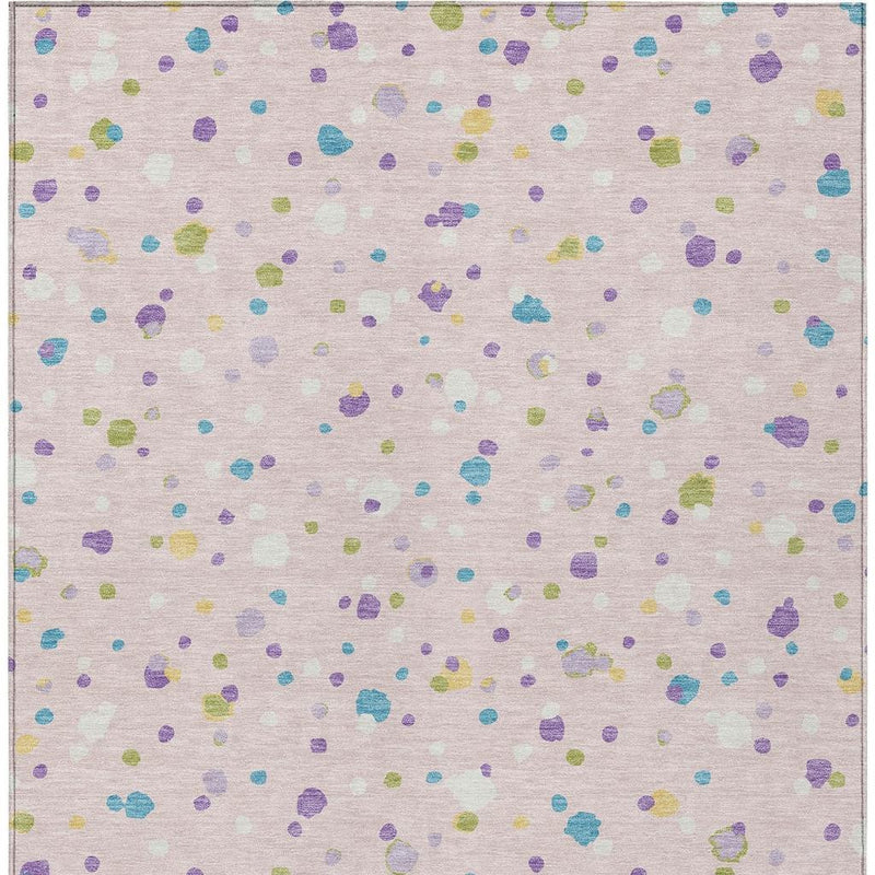 Pink and ivory area rug with all-over scattered geometric dots in purple, blue, green