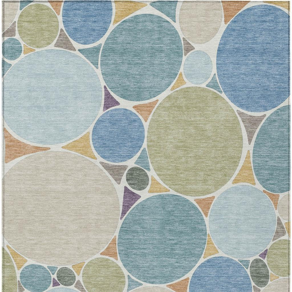Geometric area rug with large multicolor circles and small dot accents on beige ground