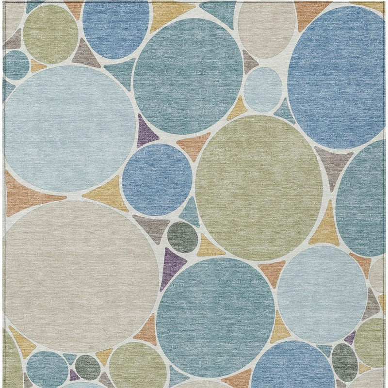 Geometric area rug with large multicolor circles and small dot accents on beige ground