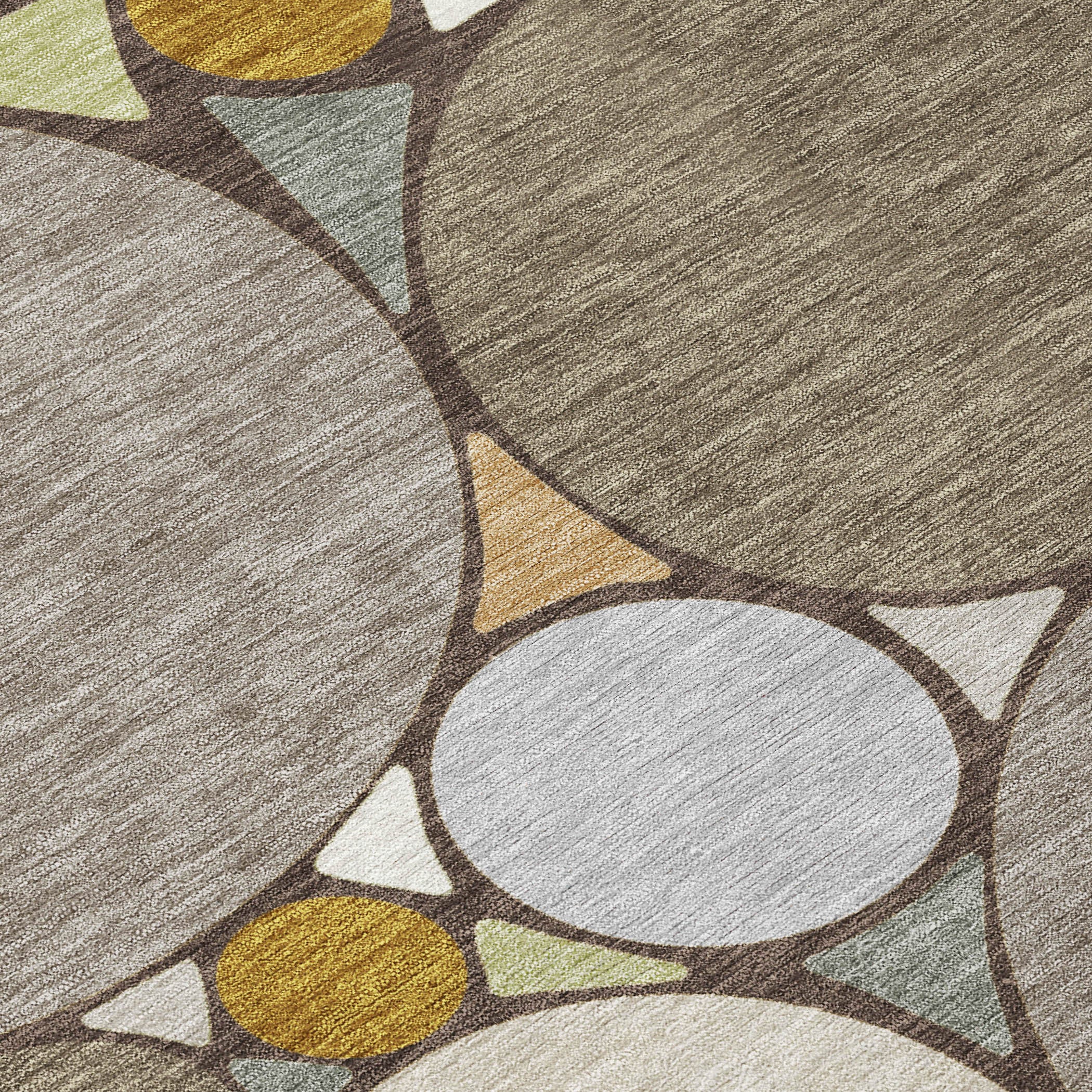 Geometric area rug close-up with gray base, cream circles, tan oval, and mustard accents