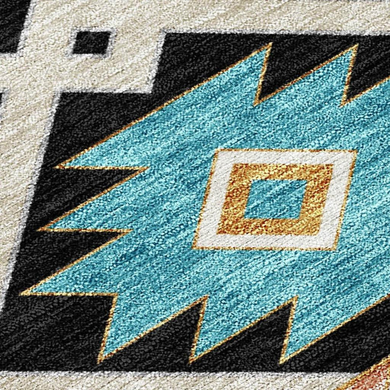 Southwestern area rug close-up with turquoise square motif on gray ground and black accents.