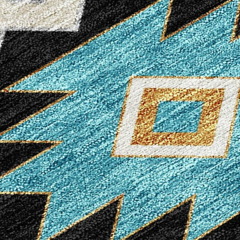 Southwestern area rug close-up with turquoise, black and gold geometric diamond patterns.