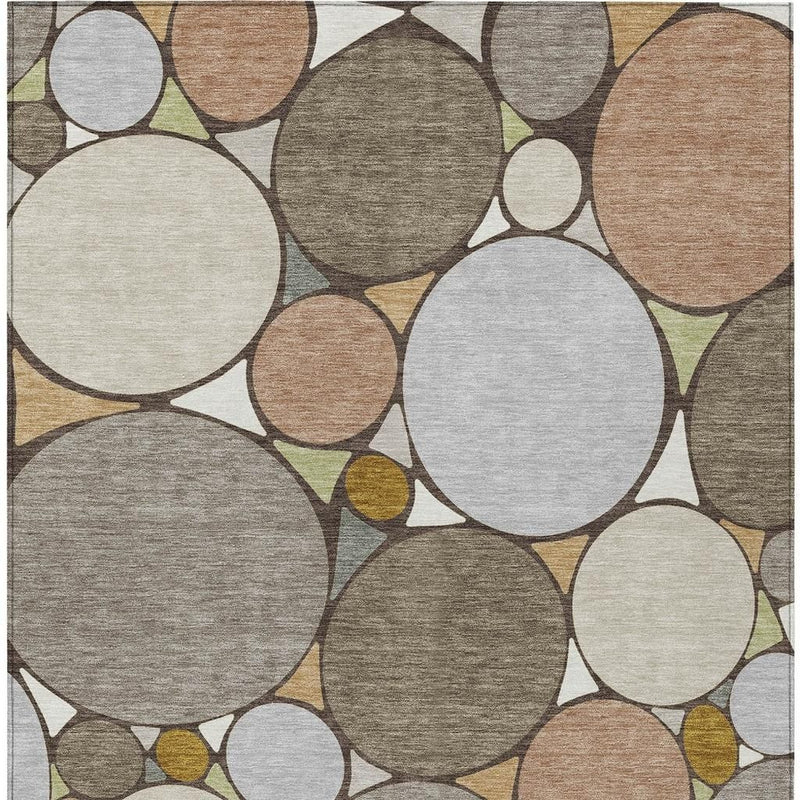 Geometric circle motif area rug in taupe, beige, gray, and cream with thin border