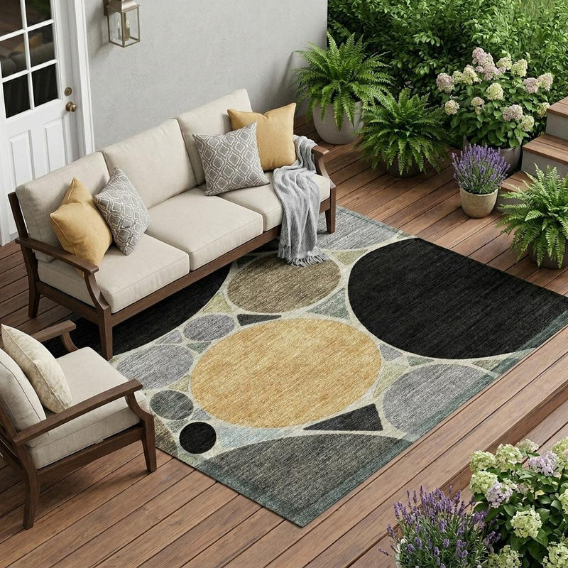 Geometric area rug with circular pattern in black, gray, and muted gold on a flat weave
