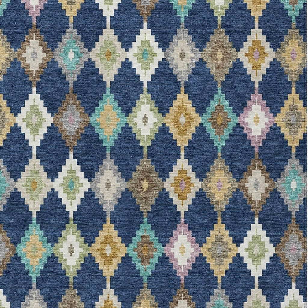 Blue aztec area rug with repeating diamond and geometric pattern in cream, teal, tan, mauve
