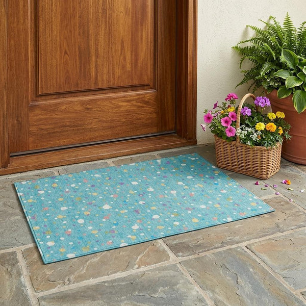 Teal blue area rug with pink, yellow, white and purple geometric speckle pattern