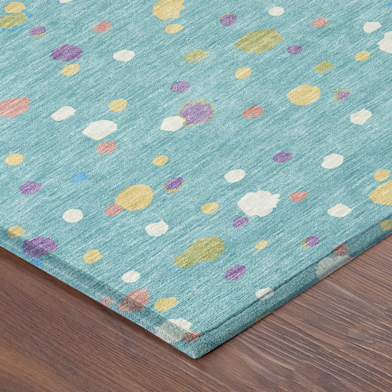 Teal blue area rug corner close-up with multicolor geometric speckles