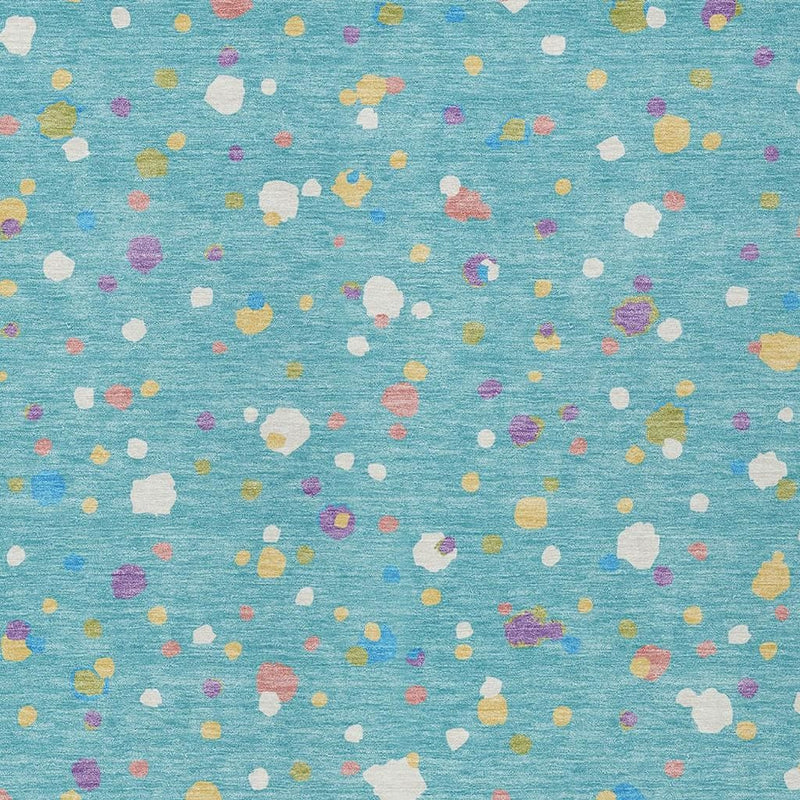 Teal blue rug surface with scattered white, purple, yellow and pink speckle pattern