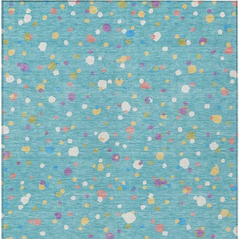 Teal blue area rug with dense multicolor geometric speckles in white, purple, yellow