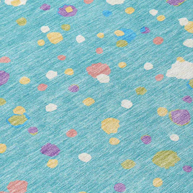Teal blue rug detail with colorful geometric speckles: white, purple, yellow, pink