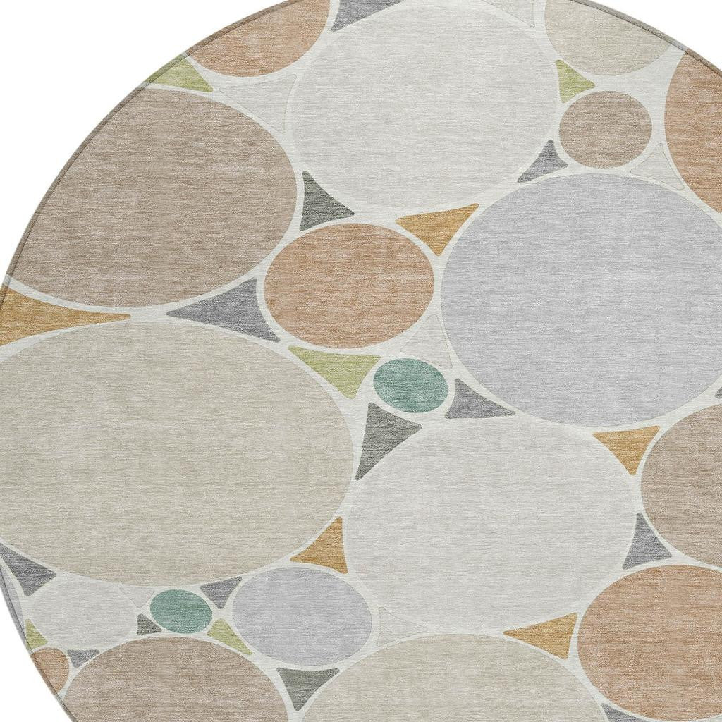 Round rug close-up with beige, gray, and teal circles and triangles geometric pattern